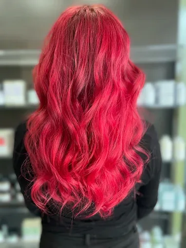 Dimensional blonde balayage with soft waves and face-framing layers